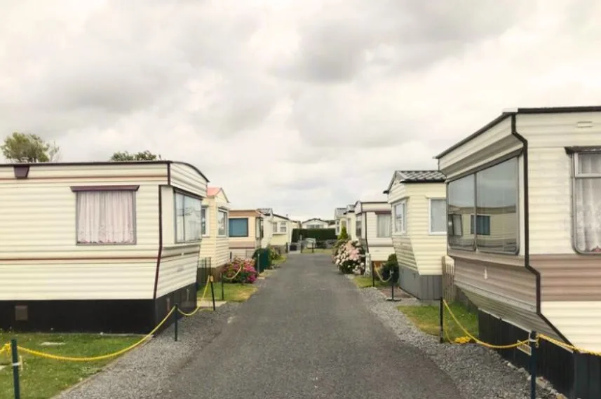 Row of mobile homes under cloudy sky